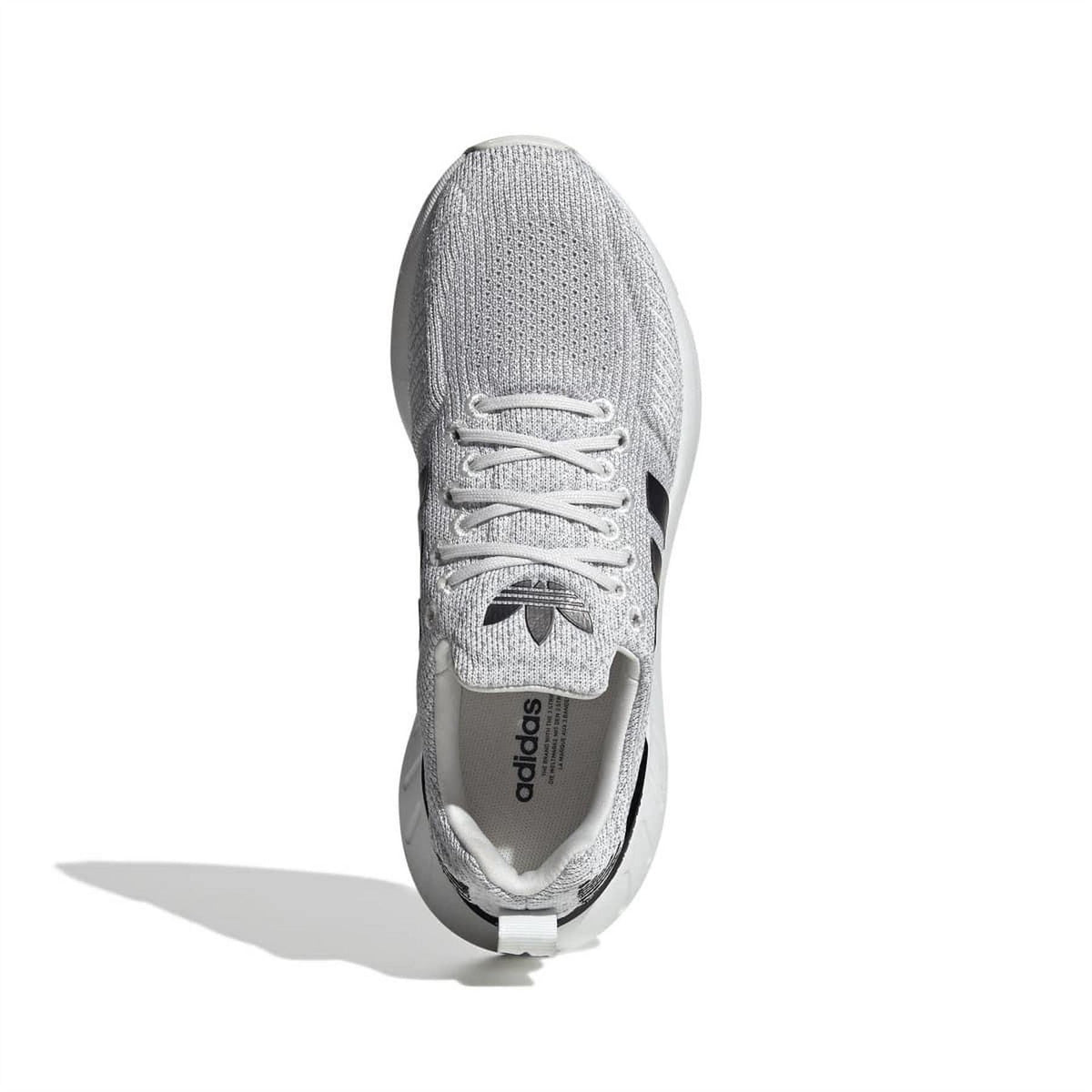 Grey adidas sneaker with lace-up front and black adidas logo on the tongue.