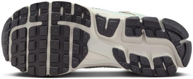 Nike Zoom Vomero 5 outsole with dark tread and light midsole, traction pattern.