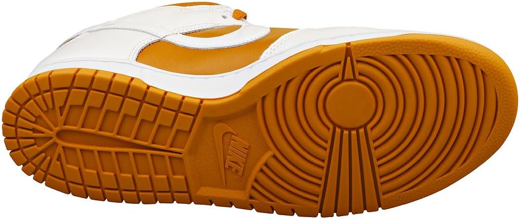 Bottom view of Nike Dunk sneakers showing gum rubber outsole tread pattern.