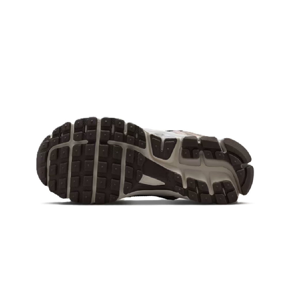 Big kid's sneaker outsole with dark rubber tread and white midfoot support