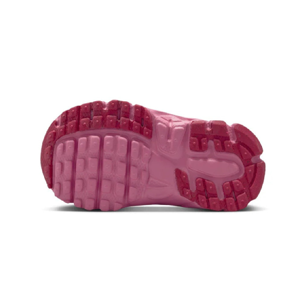 Toddler Nike outsole with pink rubber tread and multidirectional grip pattern.
