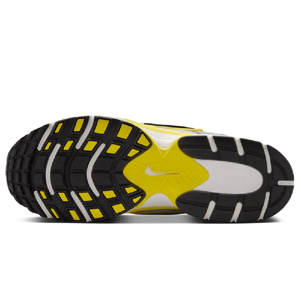 Nike running shoe outsole with grid traction in black and yellow, white midsole edge.