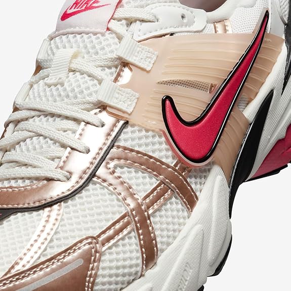 Women's Nike V2K runner sneaker close-up, white mesh and pale pink overlays with maroon swoosh