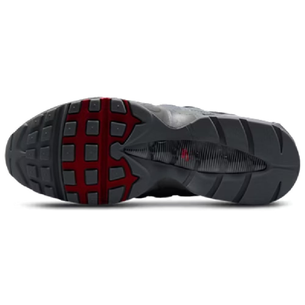Black sneaker outsoles with red traction pods and patterned rubber tread