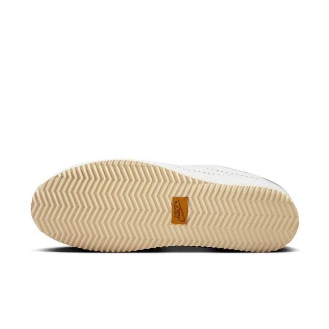 Shoe outsole with tan chevron traction and Nike logo tag on rubber sole
