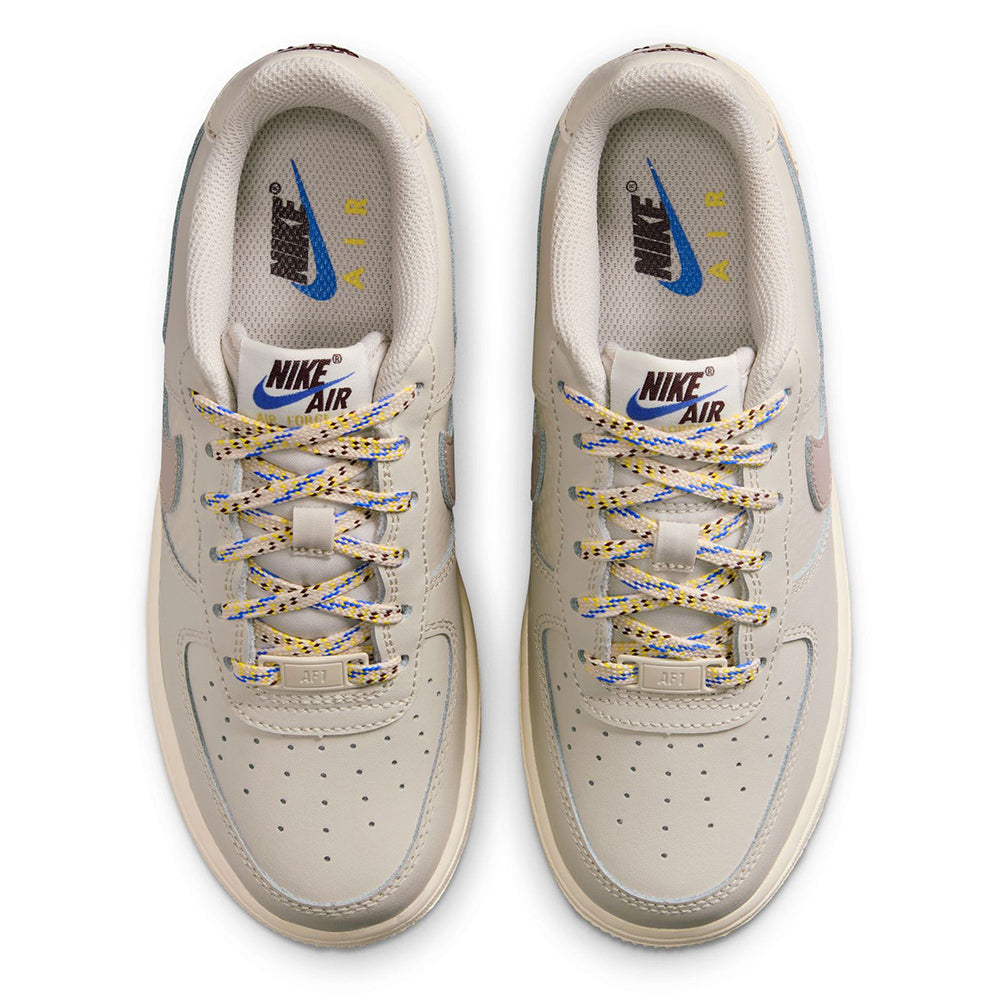 Kids' Nike Air Force 1 lace-up uppers with Nike Air tongue label and off-white perforations.