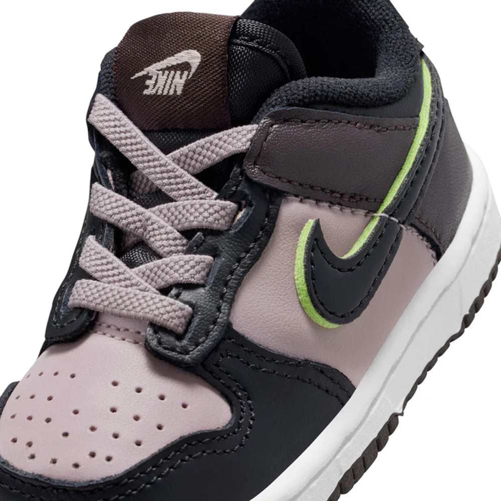 Toddler Nike Dunk Low SE close-up: particle rose leather, black laces, neon green swoosh