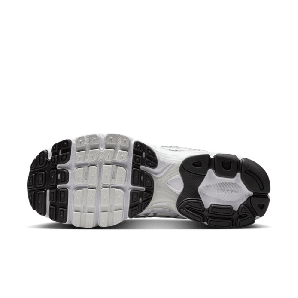 Women’s Nike Air Max Moto 2K outsole view, patterned traction sole and cushioned midfoot.