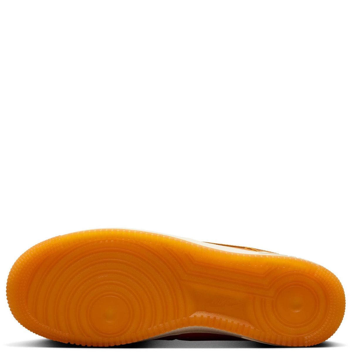 Orange rubber outsole for tan-orange low-top sneakers with circular traction pattern