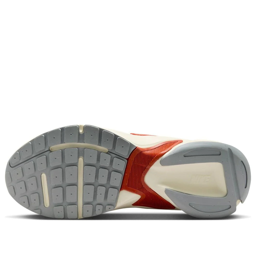 Nike women's sneakers outsole view with light gray tread and red side panel