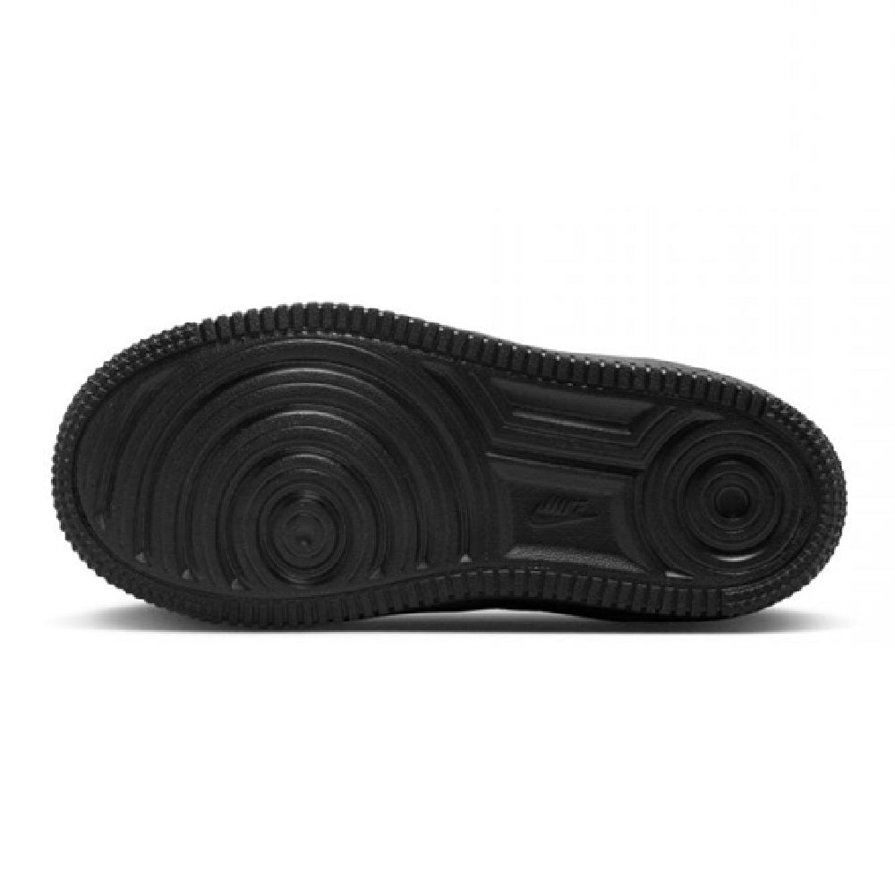 Black rubber outsole for kids’ low-top lace sneakers with circular tread pattern.