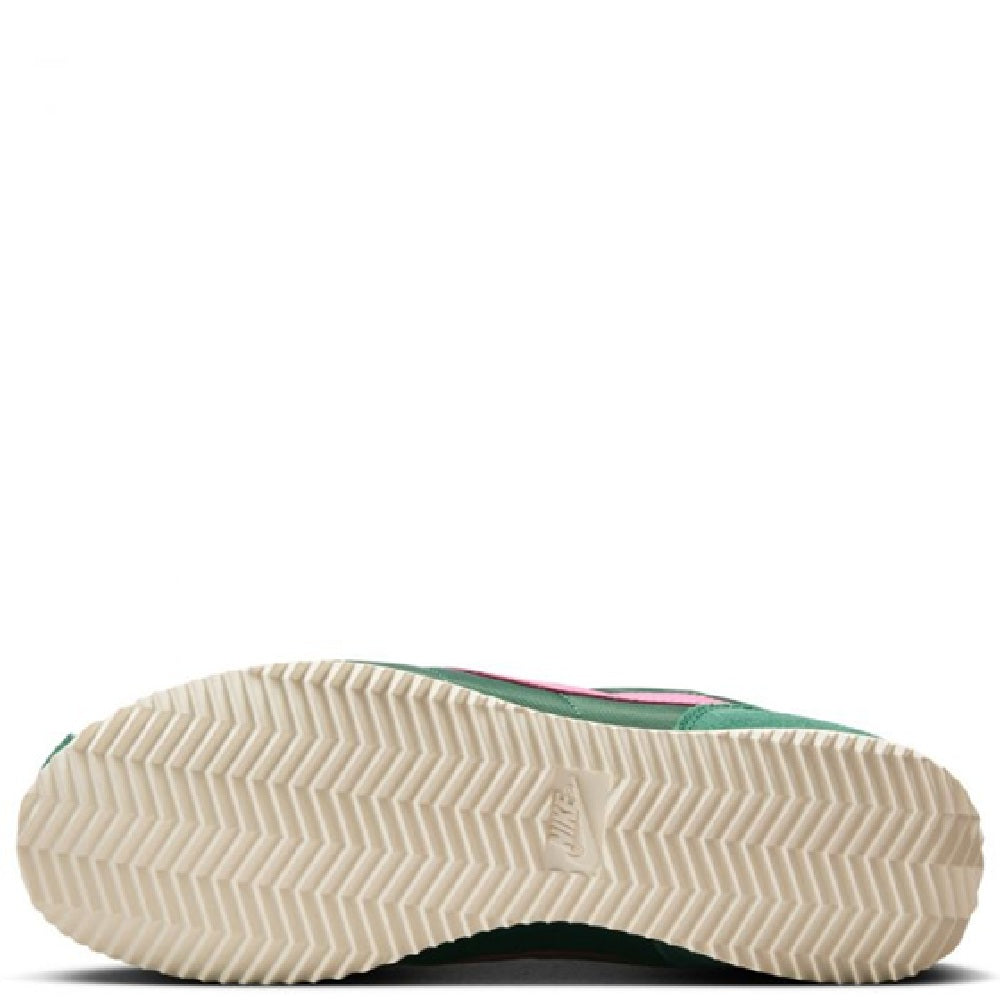 Nike Cortez sneakers outsole view, textured cream rubber sole with green upper edge