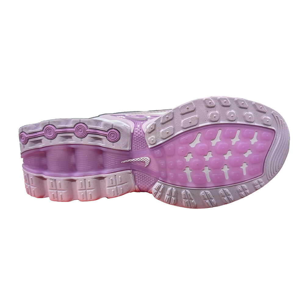 Kids' Nike outsole view with lilac and purple traction tread and molded grip pods