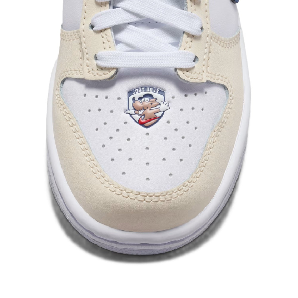 Kids' Nike Dunk Low sneakers close-up with cartoon logo on light cream toe panel