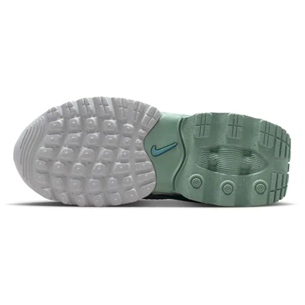 Kids sneaker outsole view with white rubber tread and green heel and side details
