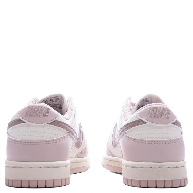 Pair of Nike low-top sneakers, back view with Nike heel branding and rubber outsole.