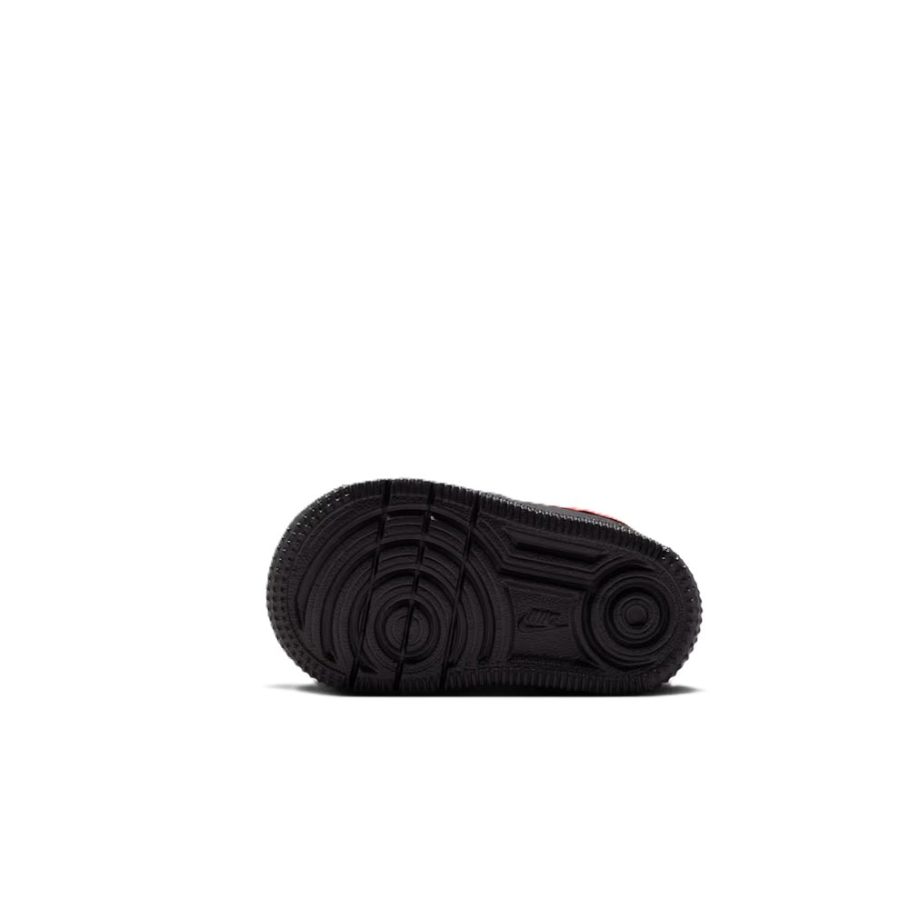 Toddler sneaker outsole tread, black rubber sole with circular traction pattern.