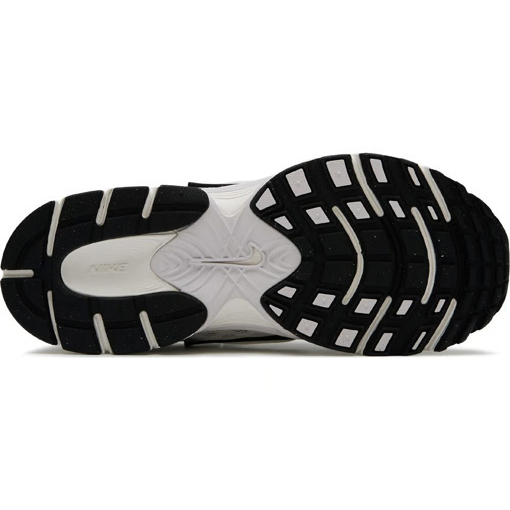 Nike running sneaker outsole, black tread with white midsole and gray traction pods