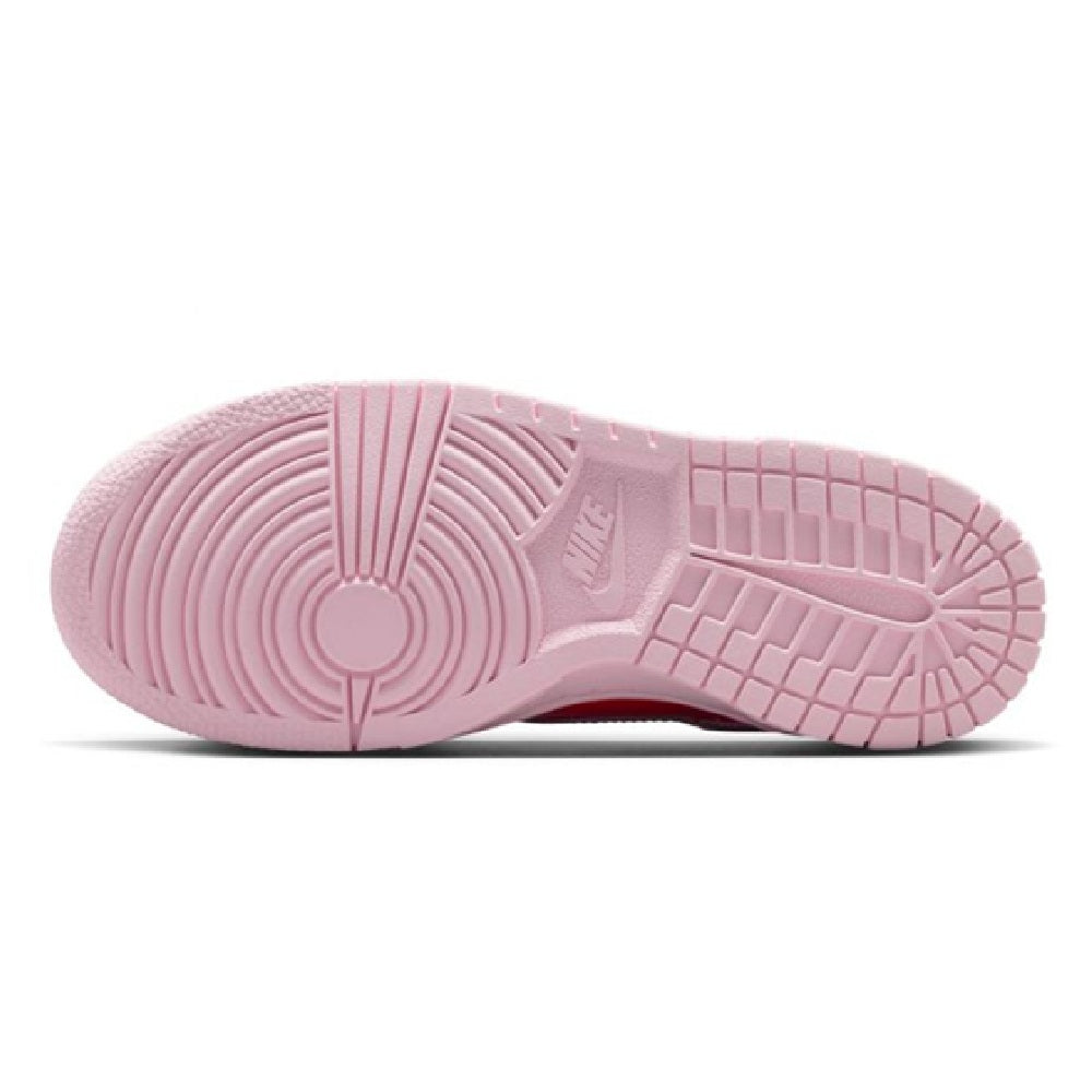 Pink rubber outsole of low-top kids sneakers with traction tread pattern.