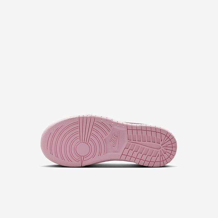 Kids sneaker outsole in pink rubber with tread grooves and circular traction pattern