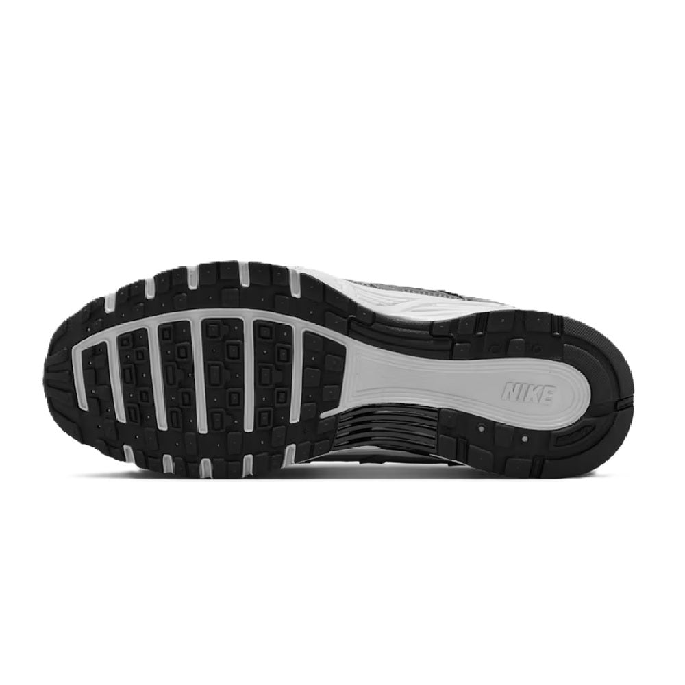 Nike P-6000 running shoe outsole with black traction tread and white midsole.