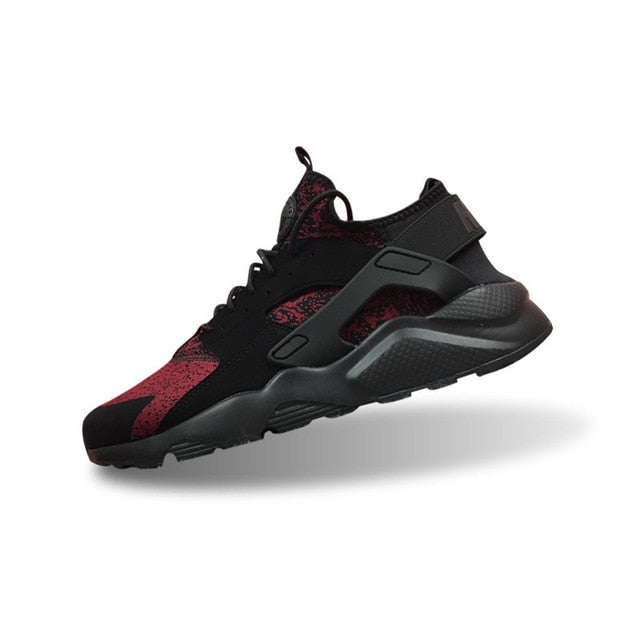 Nike Air Huarache running shoes in black with red speckled panel and dark gray sole
