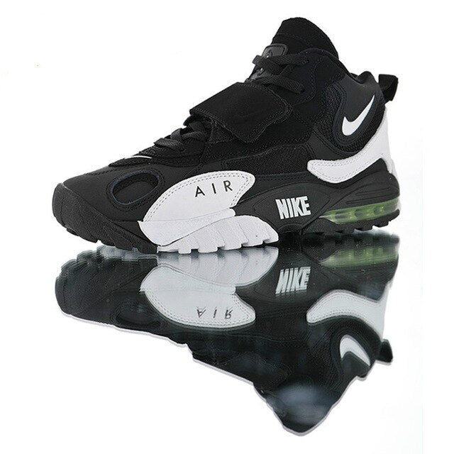 Black running sneakers with white side panel, Nike swoosh, green-tinted Air unit