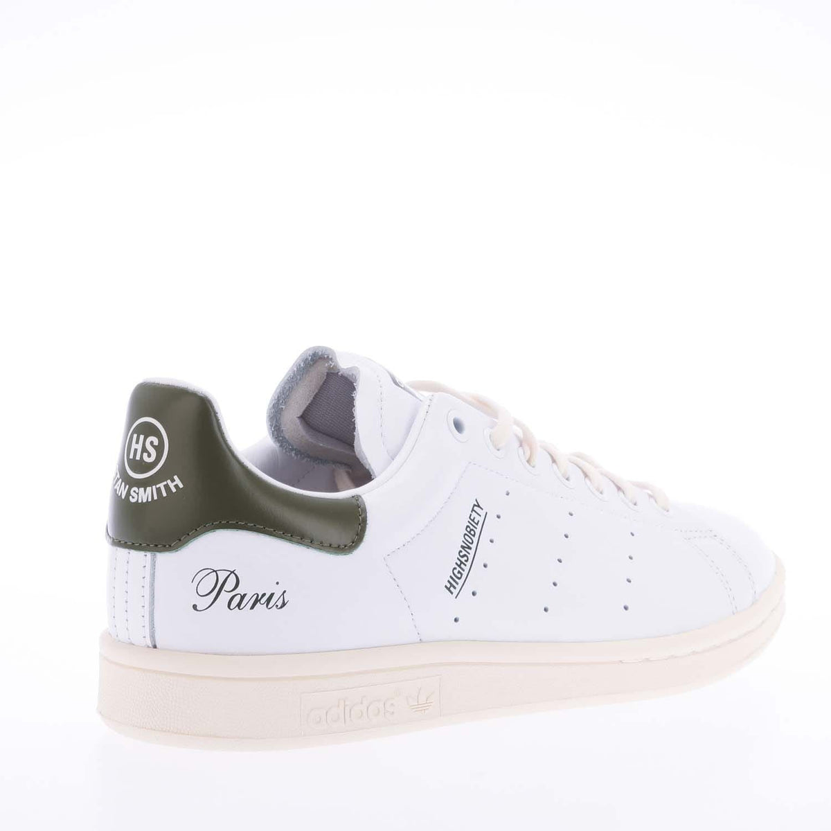 White high-top sneakers with green heel panel and 'Paris' side script detail
