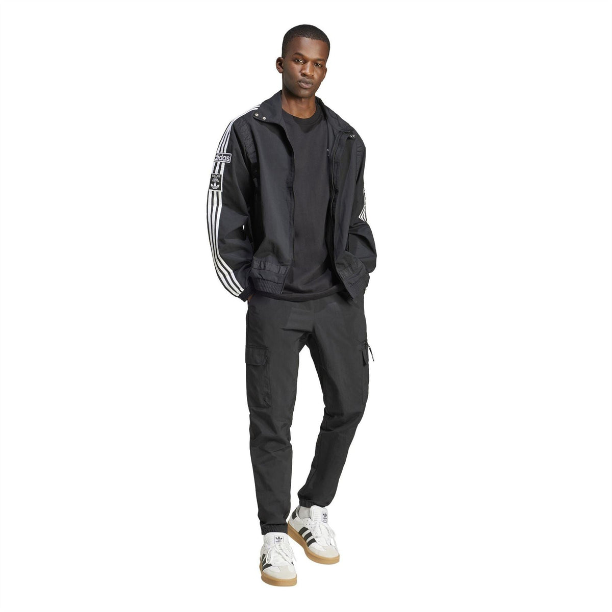 Black cargo pants with multiple pockets and adidas trefoil at thigh