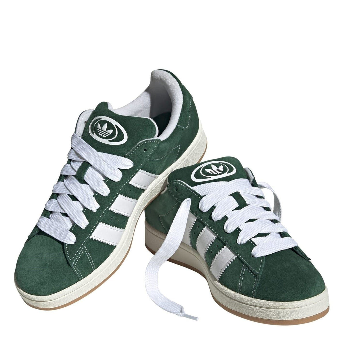 Dark green suede trainers with white laces and adidas eye logo on tongue