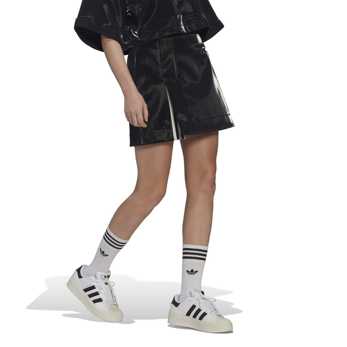 Black glossy mini skirt with front pleat and side stripe detail