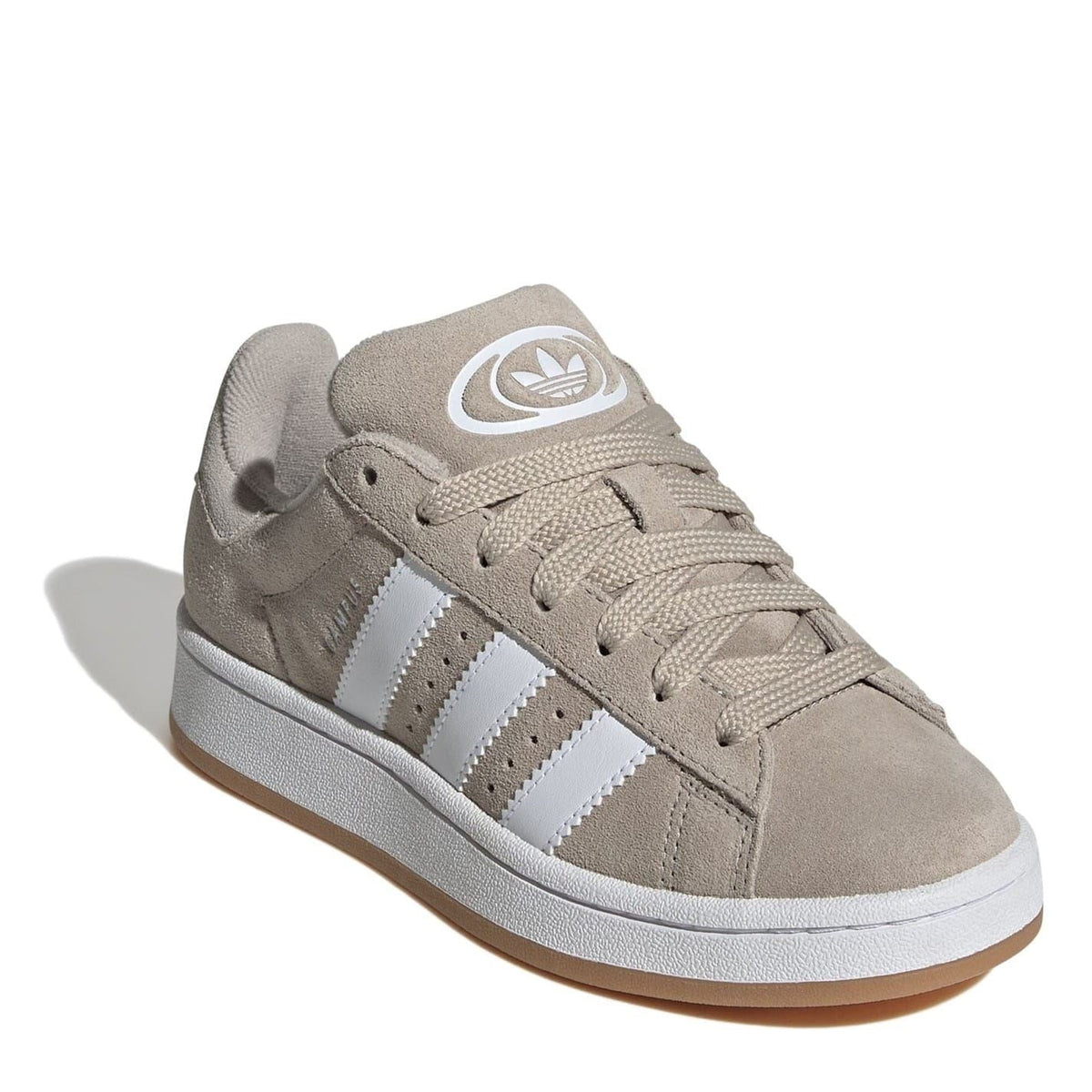 Beige suede low-top sneakers with white adidas stripes and lace-up closure
