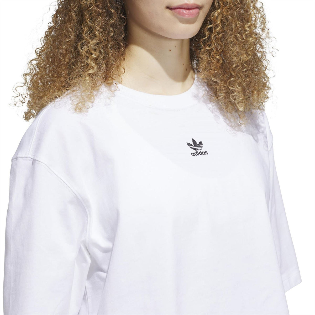 White cropped T-shirt close-up with adidas trefoil logo on chest