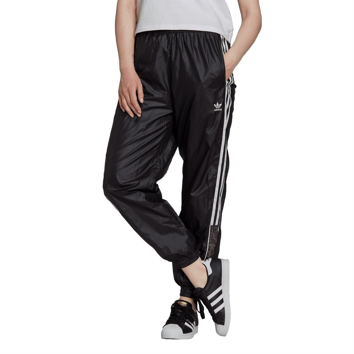Black track running sweatpants with white side stripes, elastic waistband and ankle cuffs