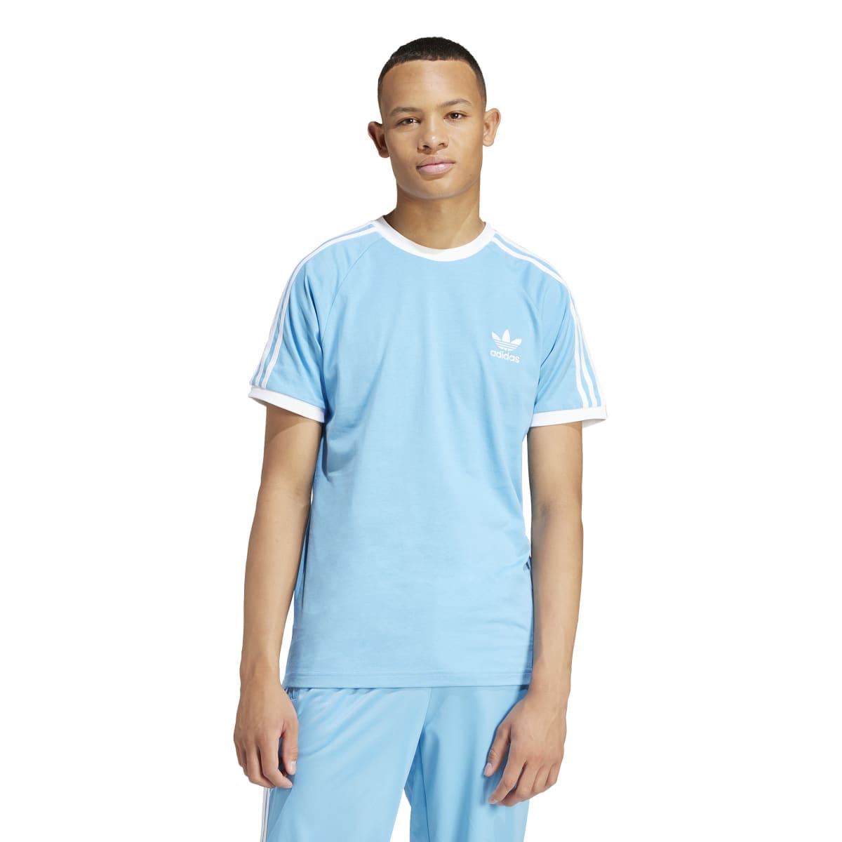 Light blue crew-neck T-shirt on model with adidas chest logo and three white stripes