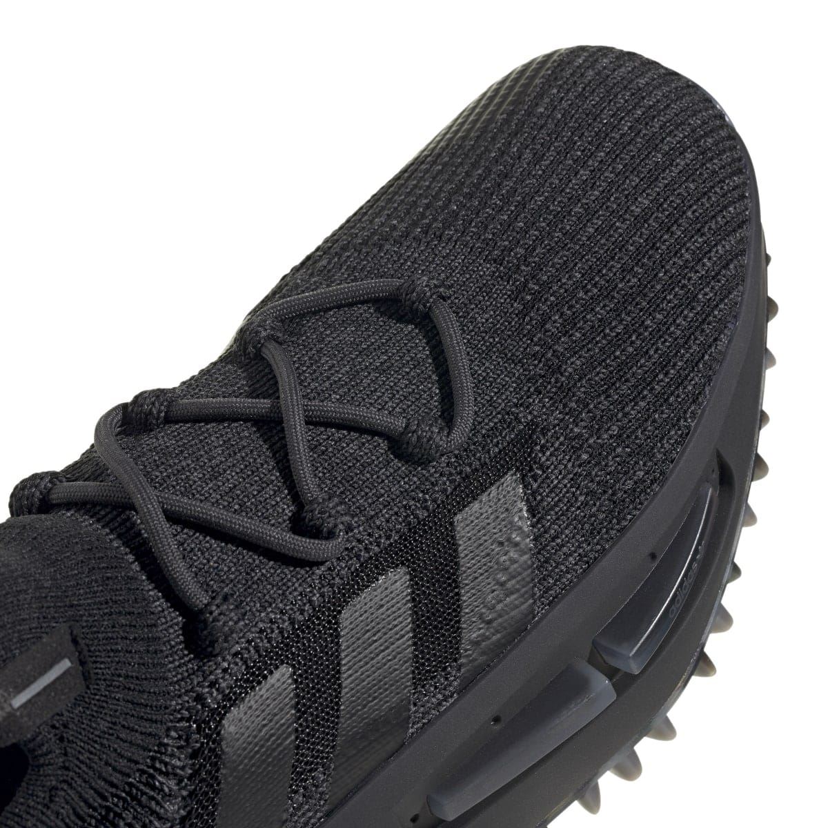 Close-up of black knit upper with lace panel and molded midfoot overlay