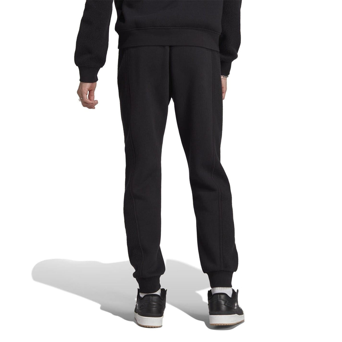Black joggers with relaxed tapered fit and ribbed cuffs at the hem