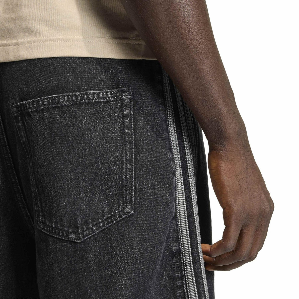 Dark denim shorts close-up: front pocket and double side stripe seam