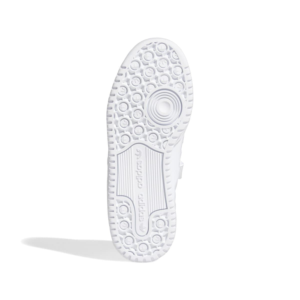 White kids trainer outsole with textured pattern and adidas logo on heel tab