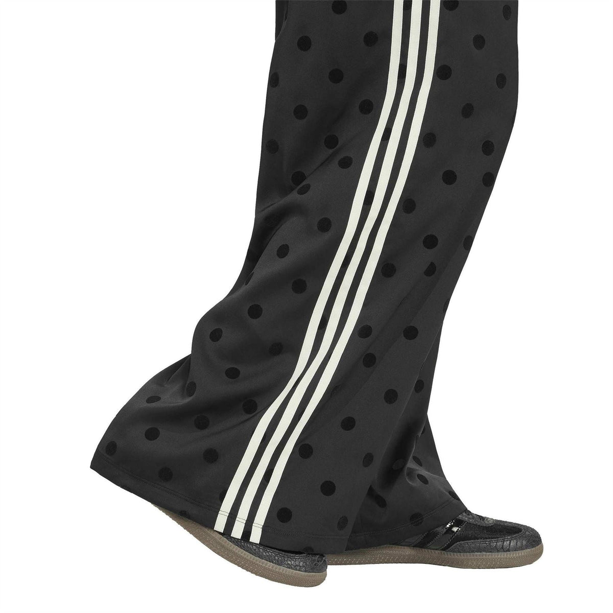 Black polka-dot wide-leg pants with elastic waist and white side stripe trim