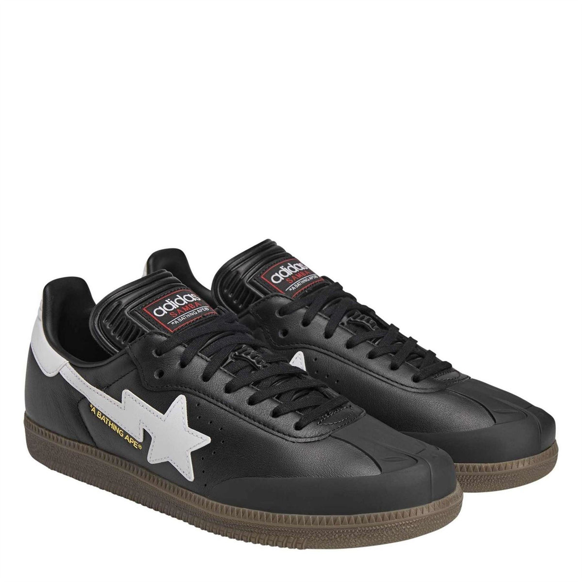Black low-top sneakers with white star emblem, black laces, and chunky outsole