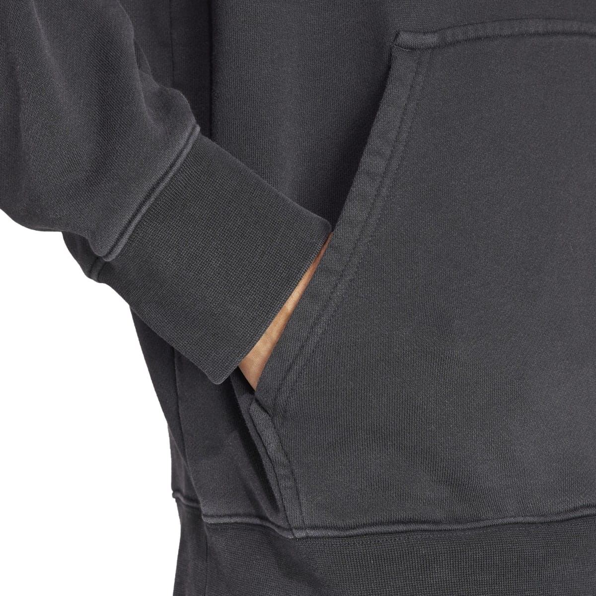 Black hoodie sleeve and kangaroo pocket seam detail