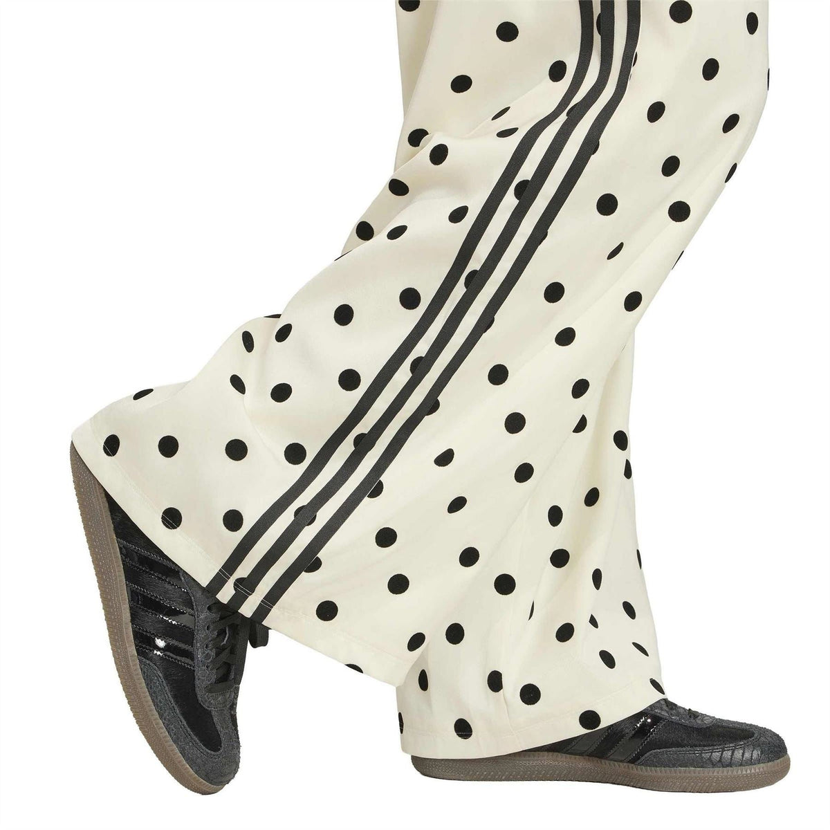 Off-white polka-dot wide-leg pants with black side stripes and elastic cuffs