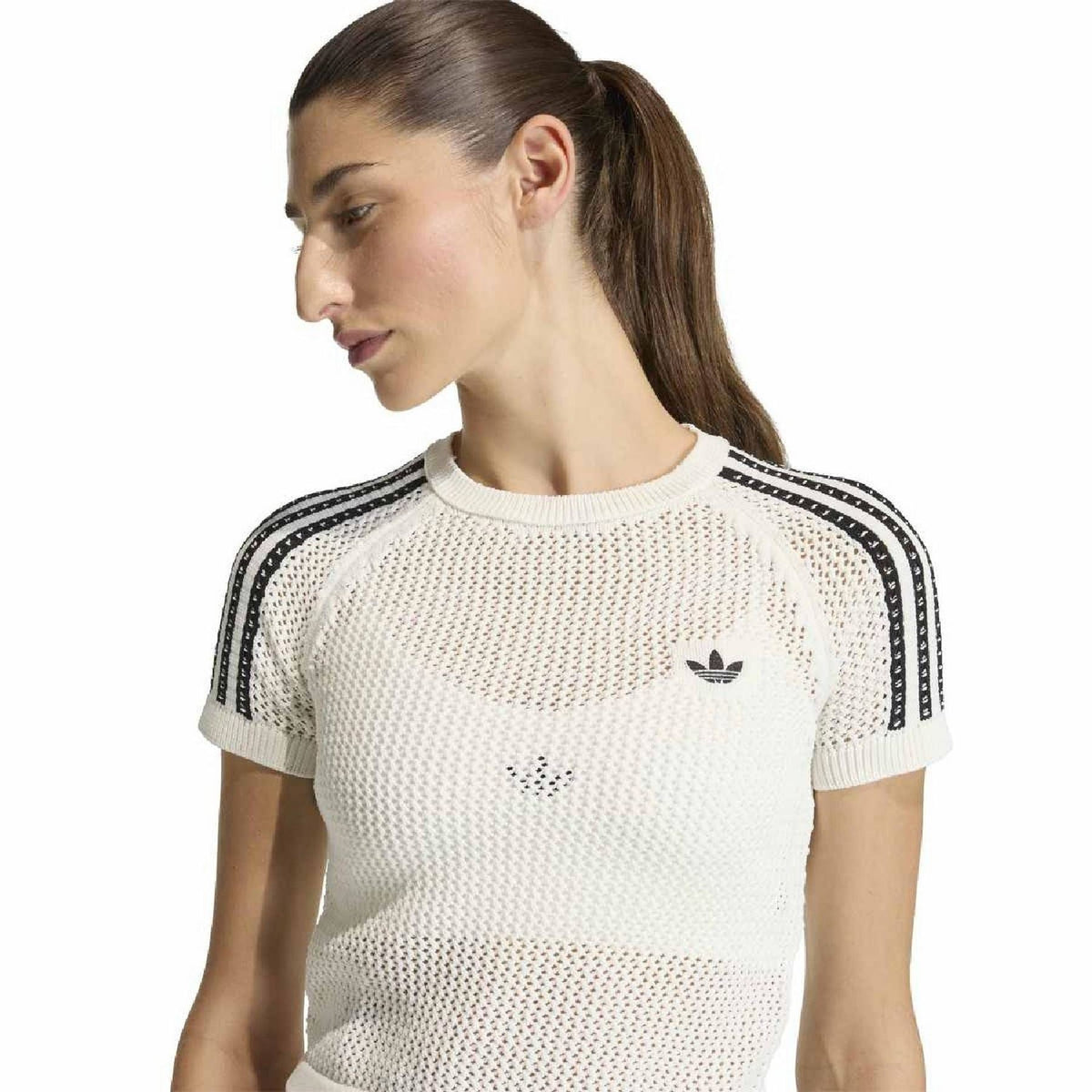 Off-white knitted crochet T-shirt close-up with crew neck, adidas trefoil, and black shoulder stripes