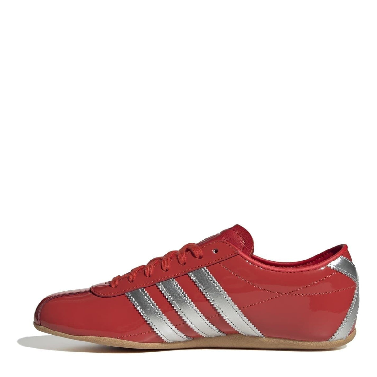 Red low-top sneakers with three metallic silver side stripes and lace-up front