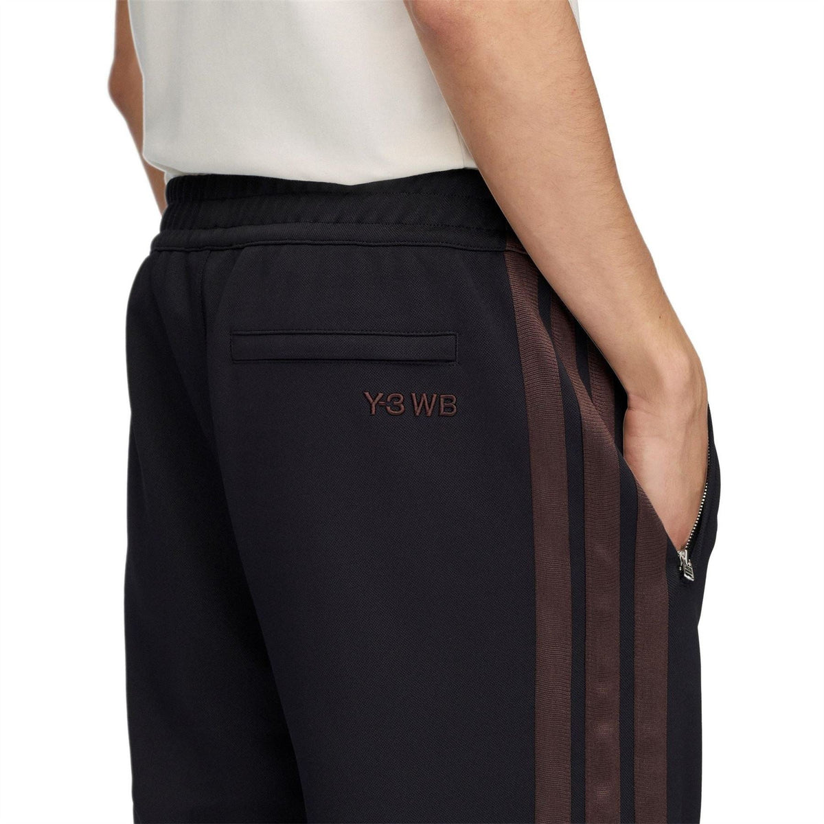 Black track pants with Y3 WB logo patch and vertical side stripe panels