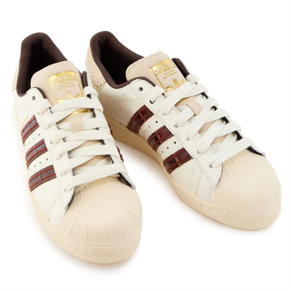 adidas Originals Superstar sneakers pair, white uppers with striped side panels and lace-up