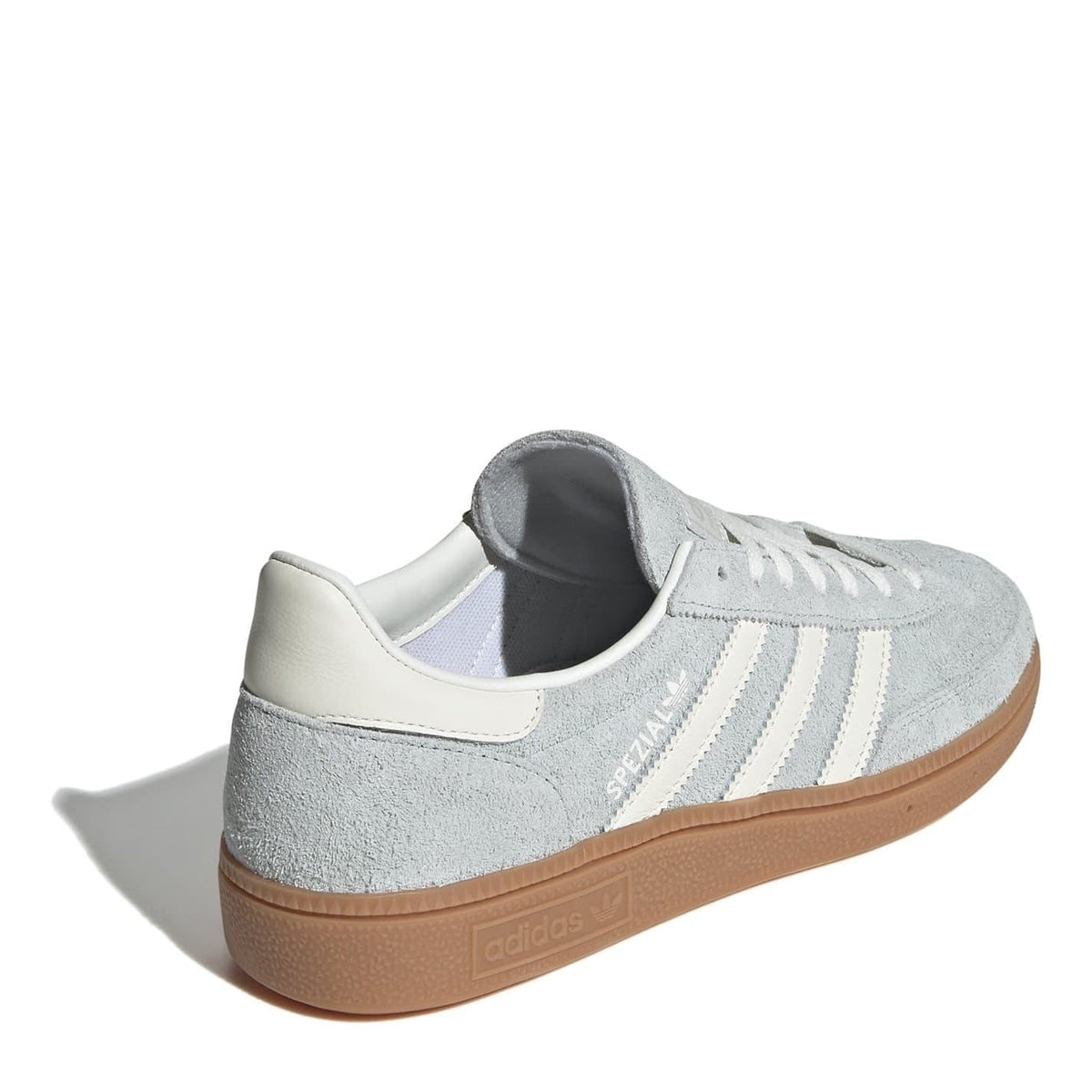 Rear view of light gray suede low-top sneakers with white collar and gum sole