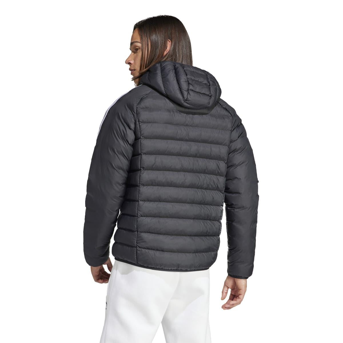 Black padded hooded puffer jacket shown from back with ribbed quilting and hood