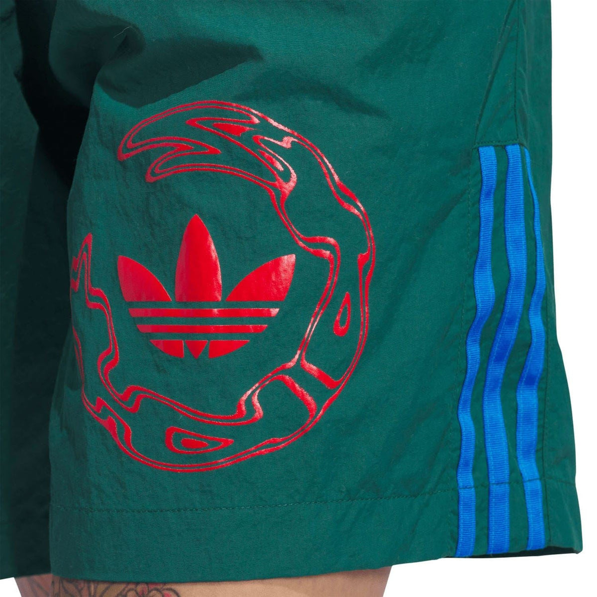 Green water shorts with red swirling logo graphic and blue side stripe